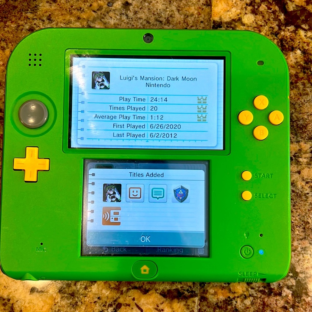 Green Nintendo 2DS w/ charger and 2 games. Zelda and Luigi’s Mansion Dark Moon.